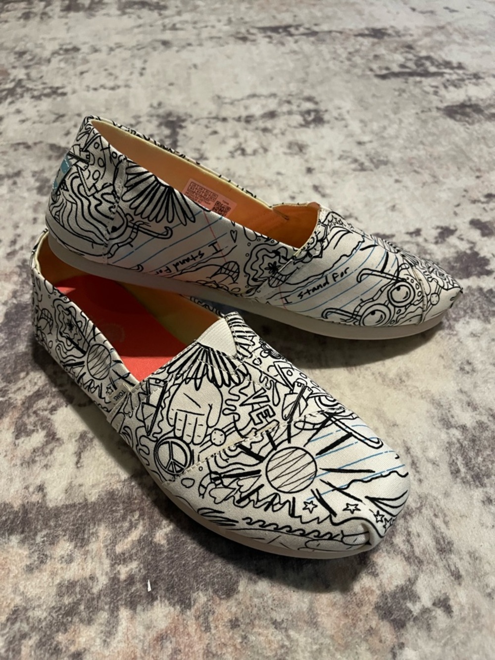 Women's White Canvas TOMS Slip-On Shoes with Black Doodle Print